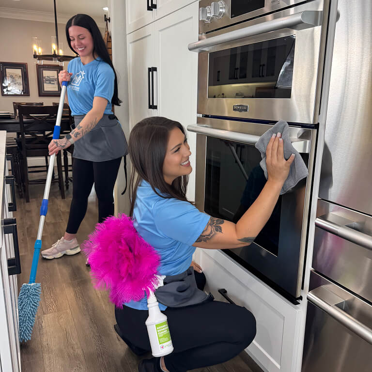 Two cleaning technicians smiling
