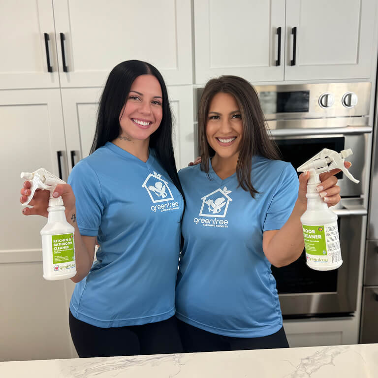 Two cleaning technicians smiling